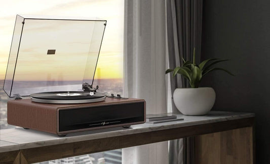 1byone h009 record player on a side table in front of a window