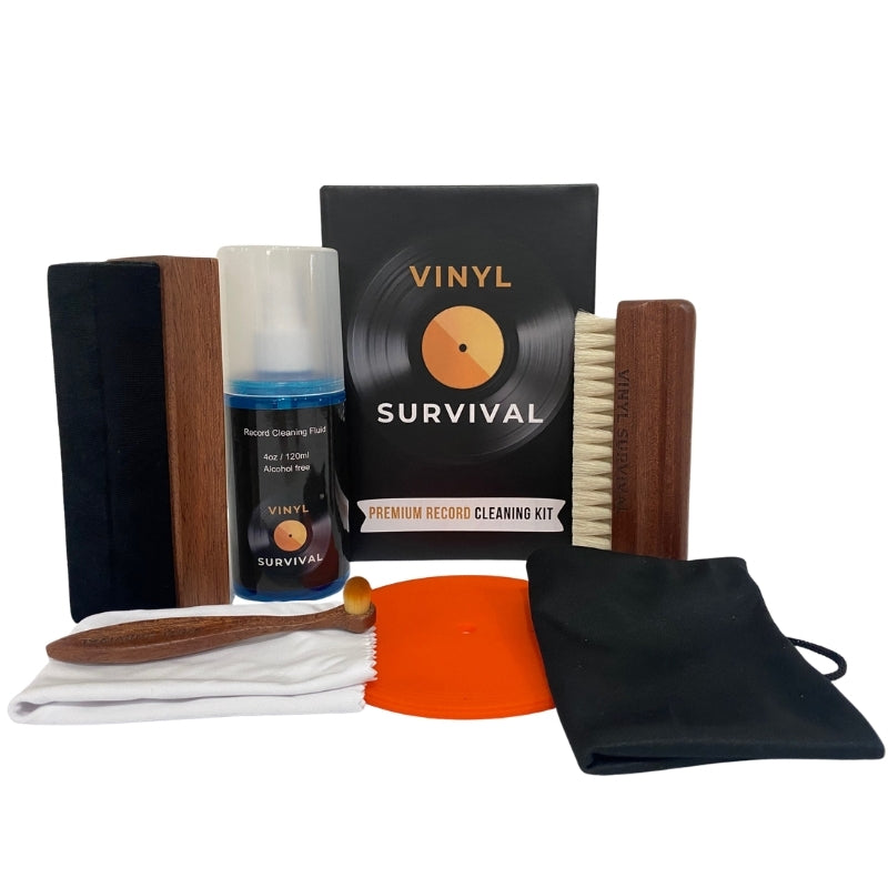 The vinyl survival record cleaning kit: velvet brush, record label, deep grove bristle brush, stylus brush, cleaning fluid, microfibre cloth, black carry bag on white background