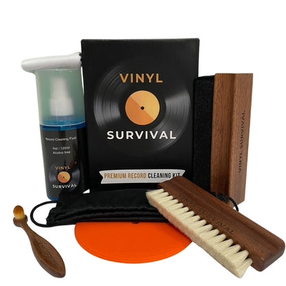 The vinyl survival record cleaning kit: velvet brush, record label, deep grove bristle brush, stylus brush, cleaning fluid, microfibre cloth, black carry bag on white background