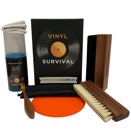 The vinyl survival record cleaning kit: velvet brush, record label, deep grove bristle brush, stylus brush, cleaning fluid, microfibre cloth, black carry bag on white background