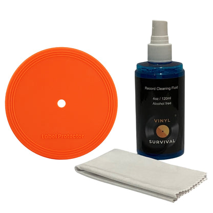 Vinyl Survival Record Cleaning Fluid kit including an orange circular label protector, a blue bottle of cleaning fluid, and a white microfiber cloth on a white background.