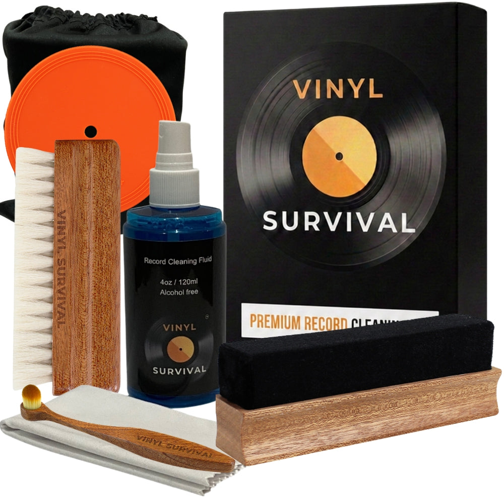 The vinyl survival record cleaning kit: velvet brush, record label, deep grove bristle brush, stylus brush, cleaning fluid, microfibre cloth, black velvet storage pouch all on white background
