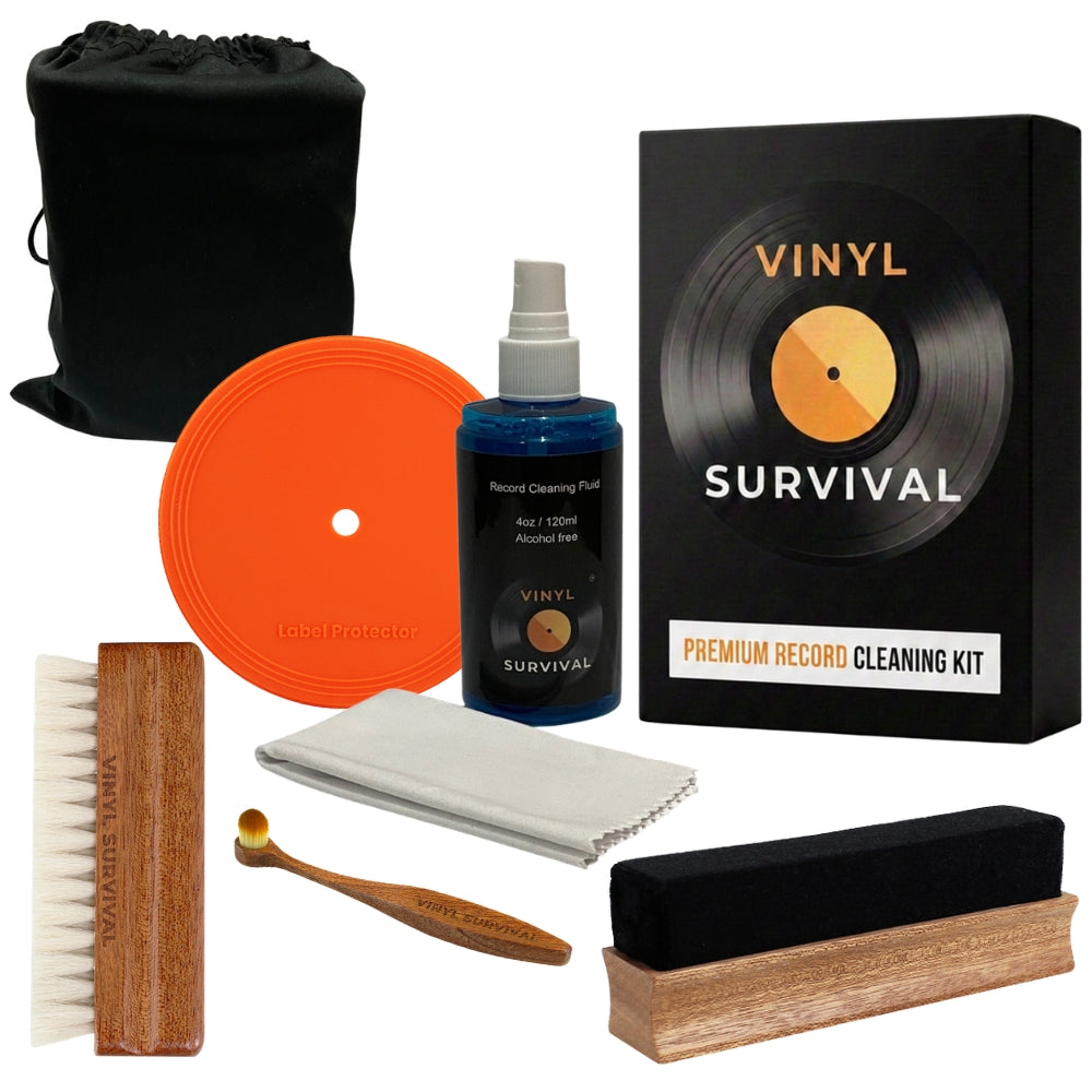 The vinyl survival record cleaning kit: velvet brush, record label, deep grove bristle brush, stylus brush, cleaning fluid, microfibre cloth, black velvet storage pouch all on white background