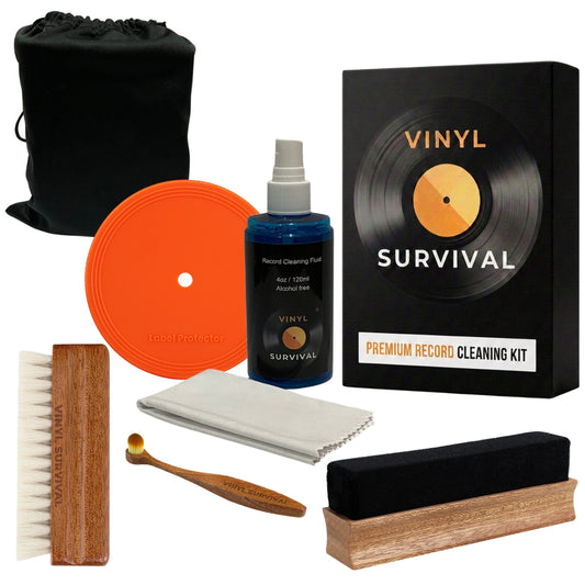 The vinyl survival record cleaning kit: velvet brush, record label, deep grove bristle brush, stylus brush, cleaning fluid, microfibre cloth, black velvet storage pouch all on white background